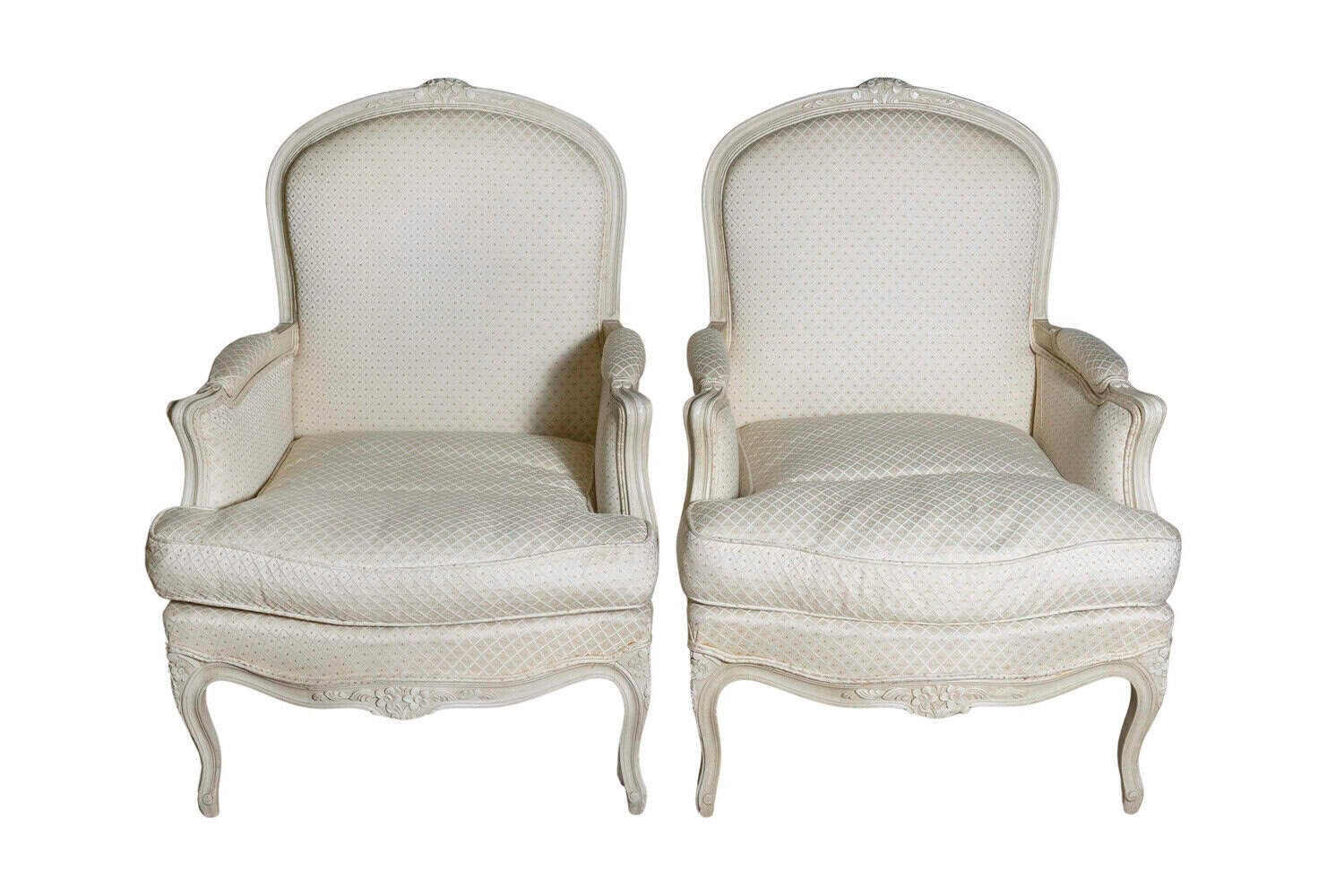 Louis XV Style French Cream Painted Wood Carved Bergères Chairs, a Pair