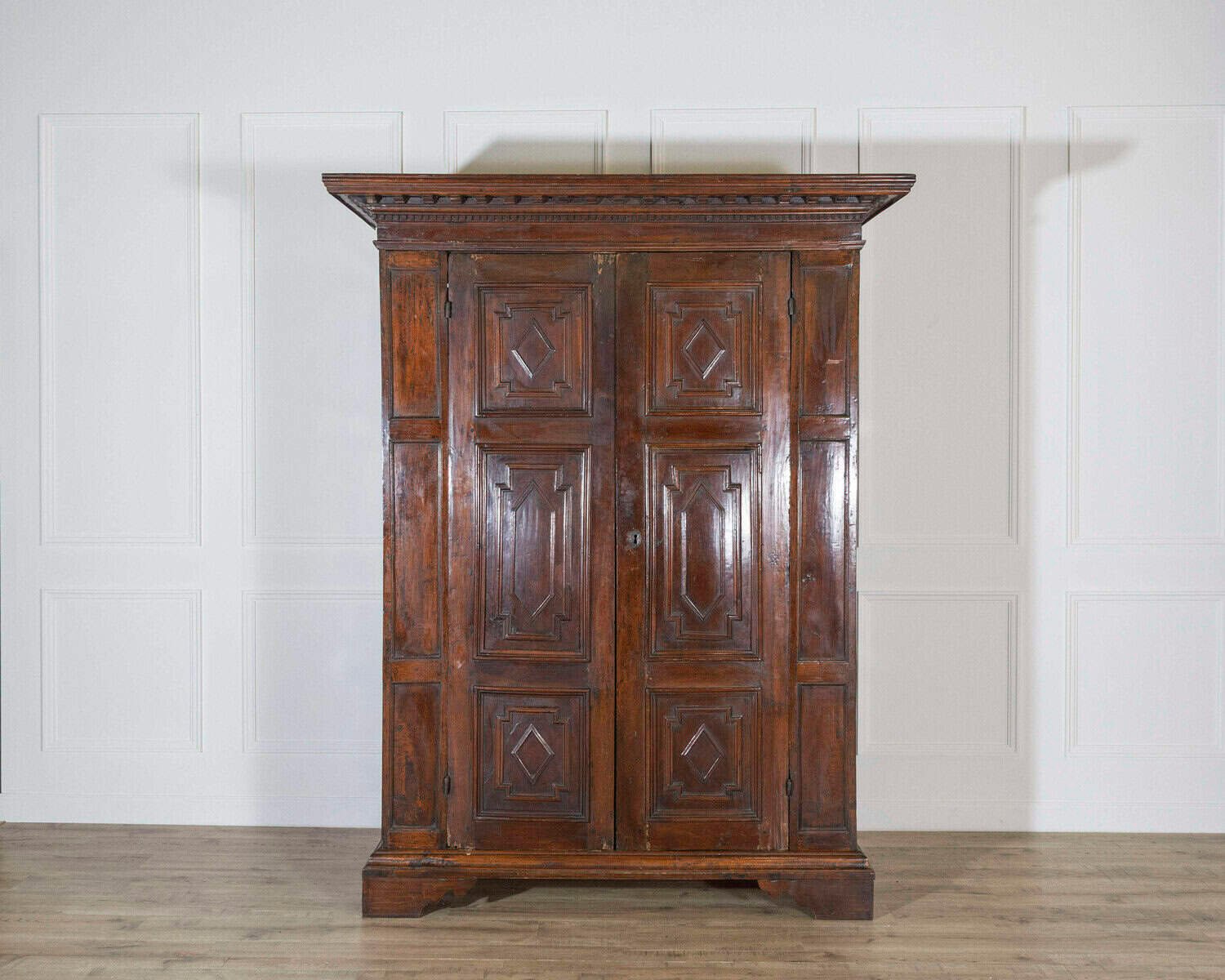 Italian 17th Century Lombard Walnut Wardrobe with Carved Pilasters, Molded Panels and Bracket Feet - JAA