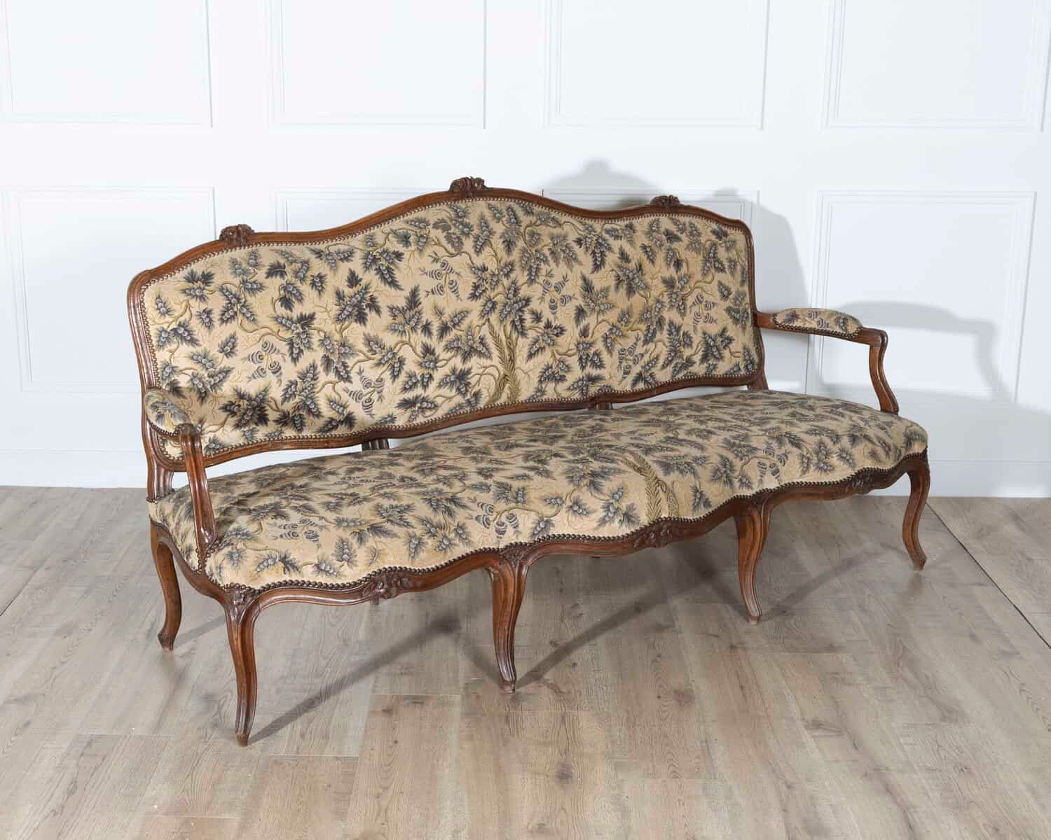 18th Century Louis XV Period Walnut Sofa with Floral Carvings and Tapestry Upholstery - JAA