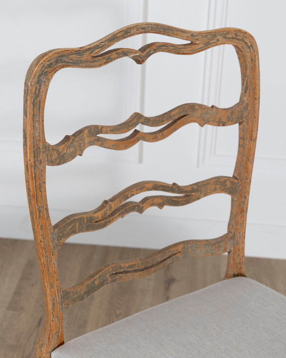 A pair of slender Gustavian chairs with smiling details, scraped to original paint and newly covered in linen. Circa 1780 - JAA