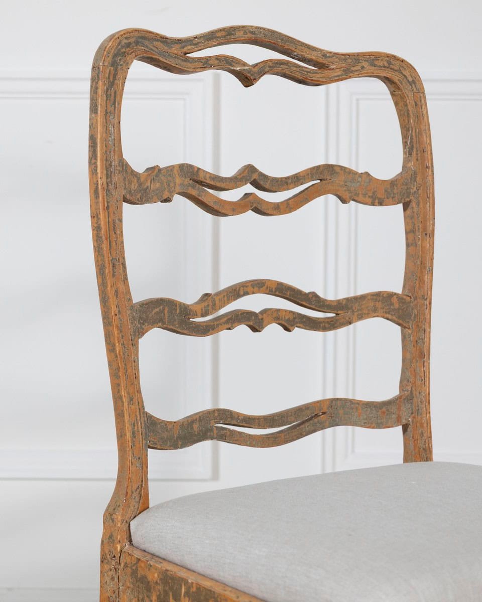 A pair of slender Gustavian chairs with smiling details, scraped to original paint and newly covered in linen. Circa 1780 - JAA