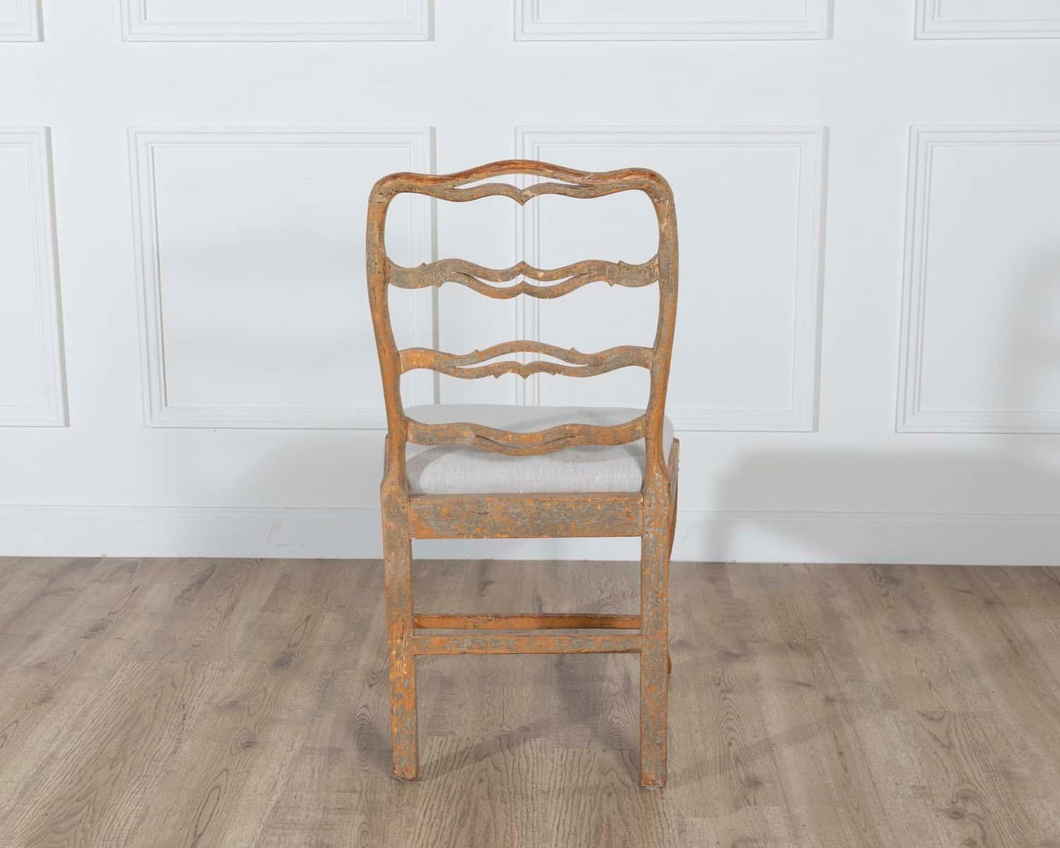 A pair of slender Gustavian chairs with smiling details, scraped to original paint and newly covered in linen. Circa 1780 - JAA