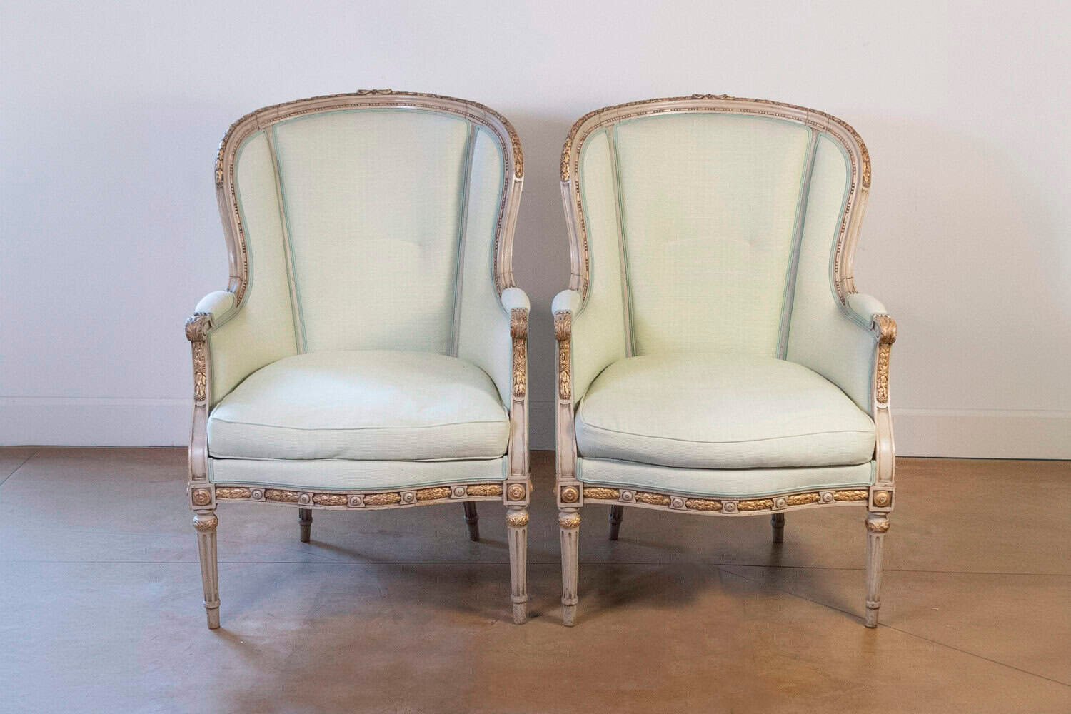 Pair of French Louis XVI Style 1900s Painted and Parcel-Gilt Bergères Chairs - JAA