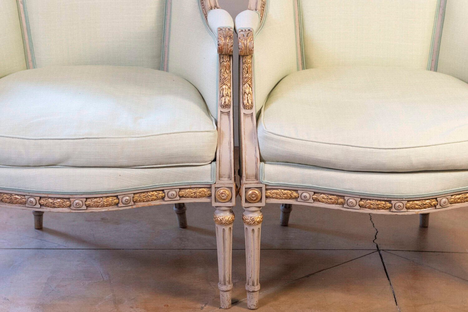 Pair of French Louis XVI Style 1900s Painted and Parcel-Gilt Bergères Chairs - JAA