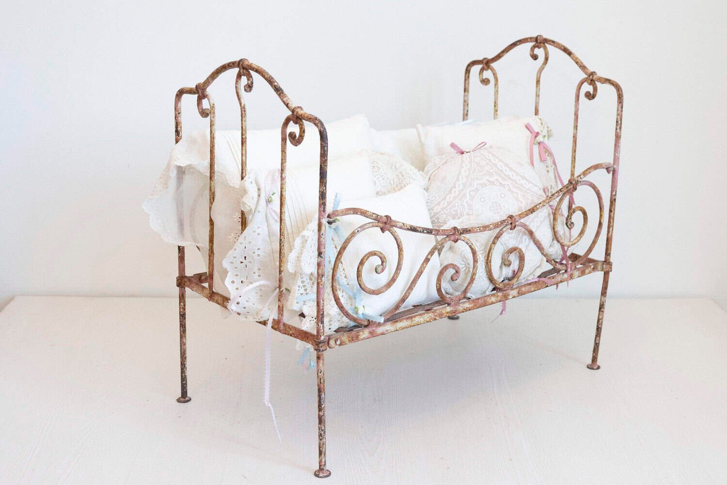 Assortment of Vintage Lace Pillows in 19th Century Metal Crib with Great Patina - JAA