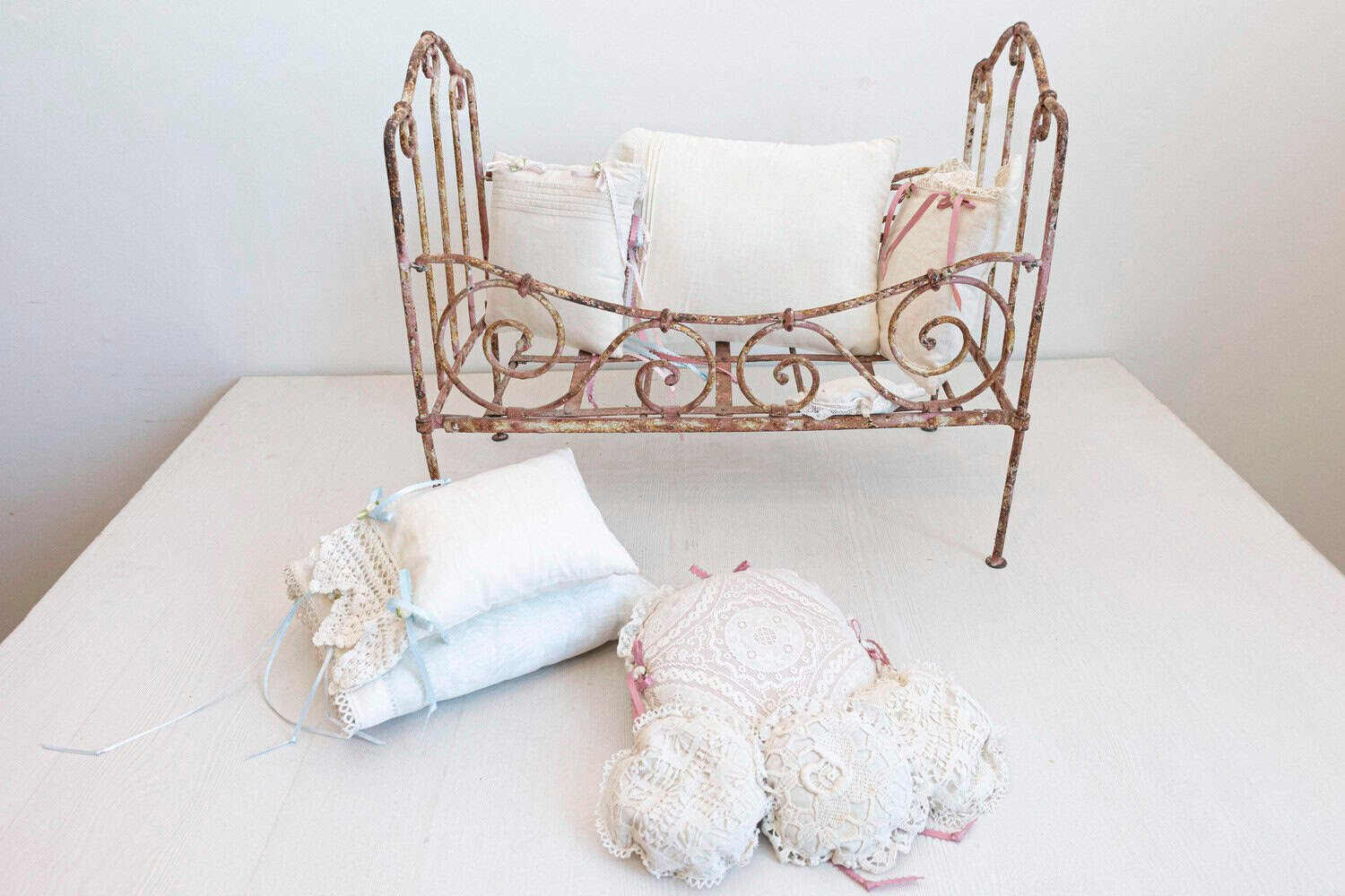 Assortment of Vintage Lace Pillows in 19th Century Metal Crib with Great Patina - JAA