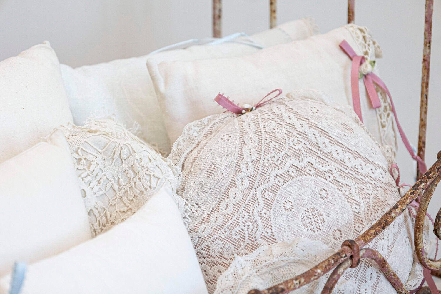 Assortment of Vintage Lace Pillows in 19th Century Metal Crib with Great Patina - JAA