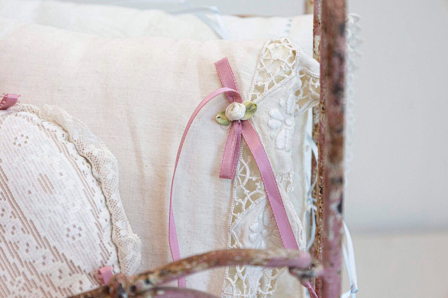 Assortment of Vintage Lace Pillows in 19th Century Metal Crib with Great Patina - JAA