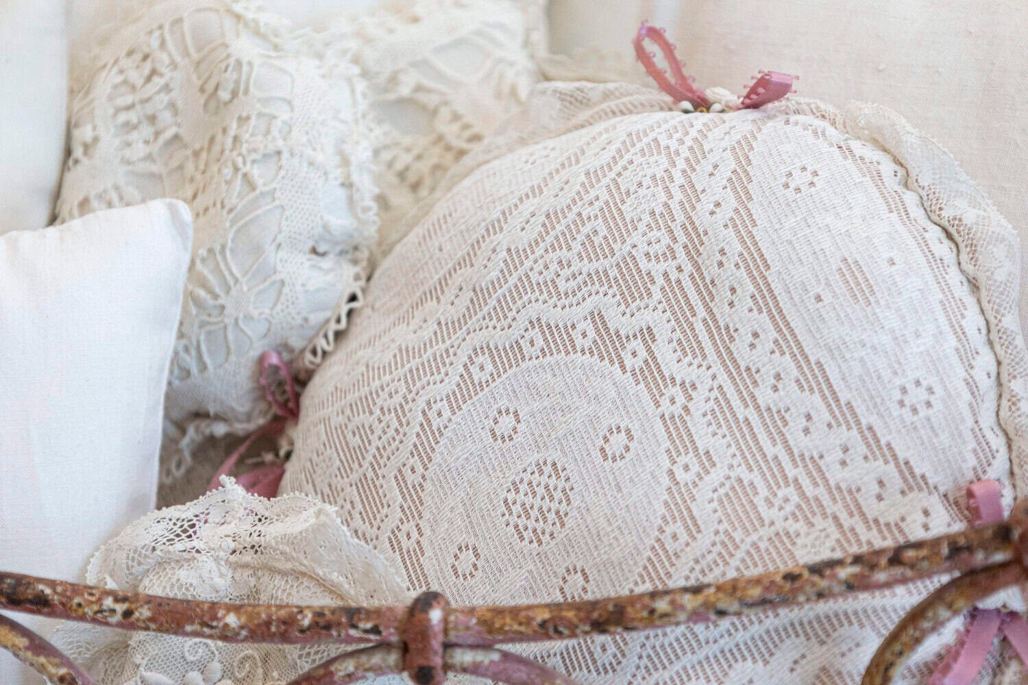 Assortment of Vintage Lace Pillows in 19th Century Metal Crib with Great Patina - JAA