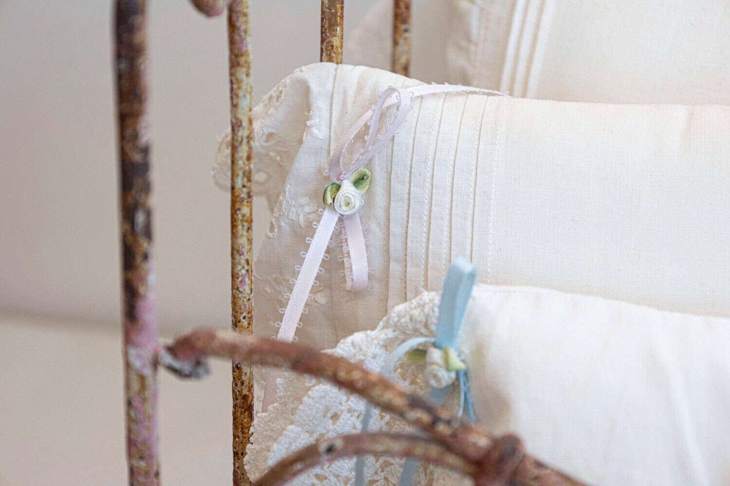 Assortment of Vintage Lace Pillows in 19th Century Metal Crib with Great Patina - JAA