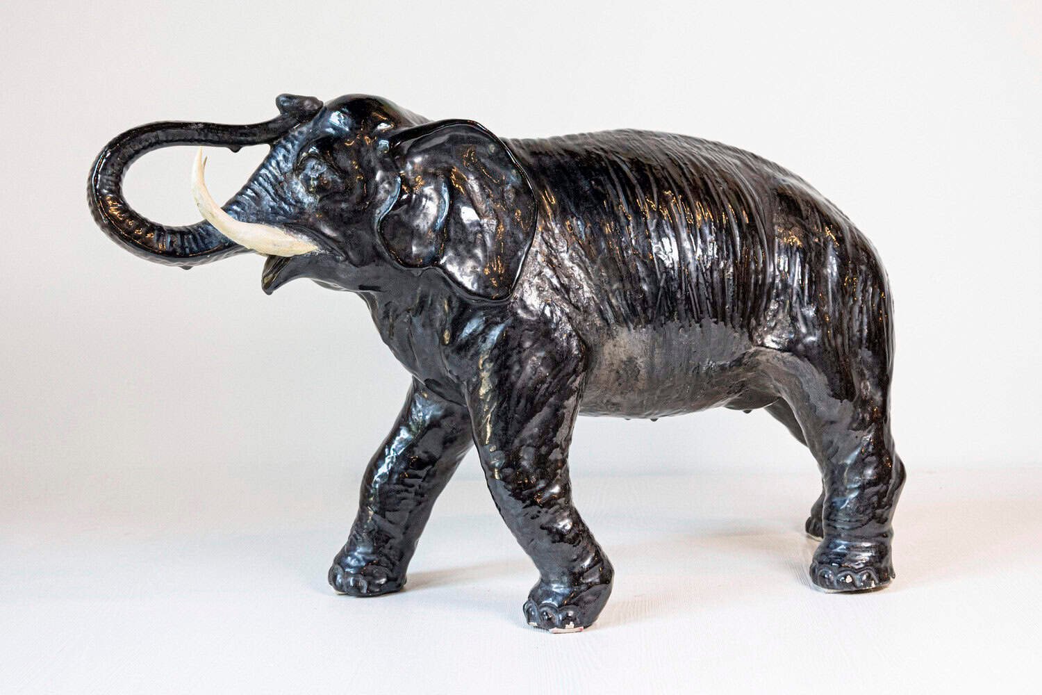 Italian 20th Century Black Glazed Ceramic Sculpture of a Walking Elephant with Trunk Up - JAA