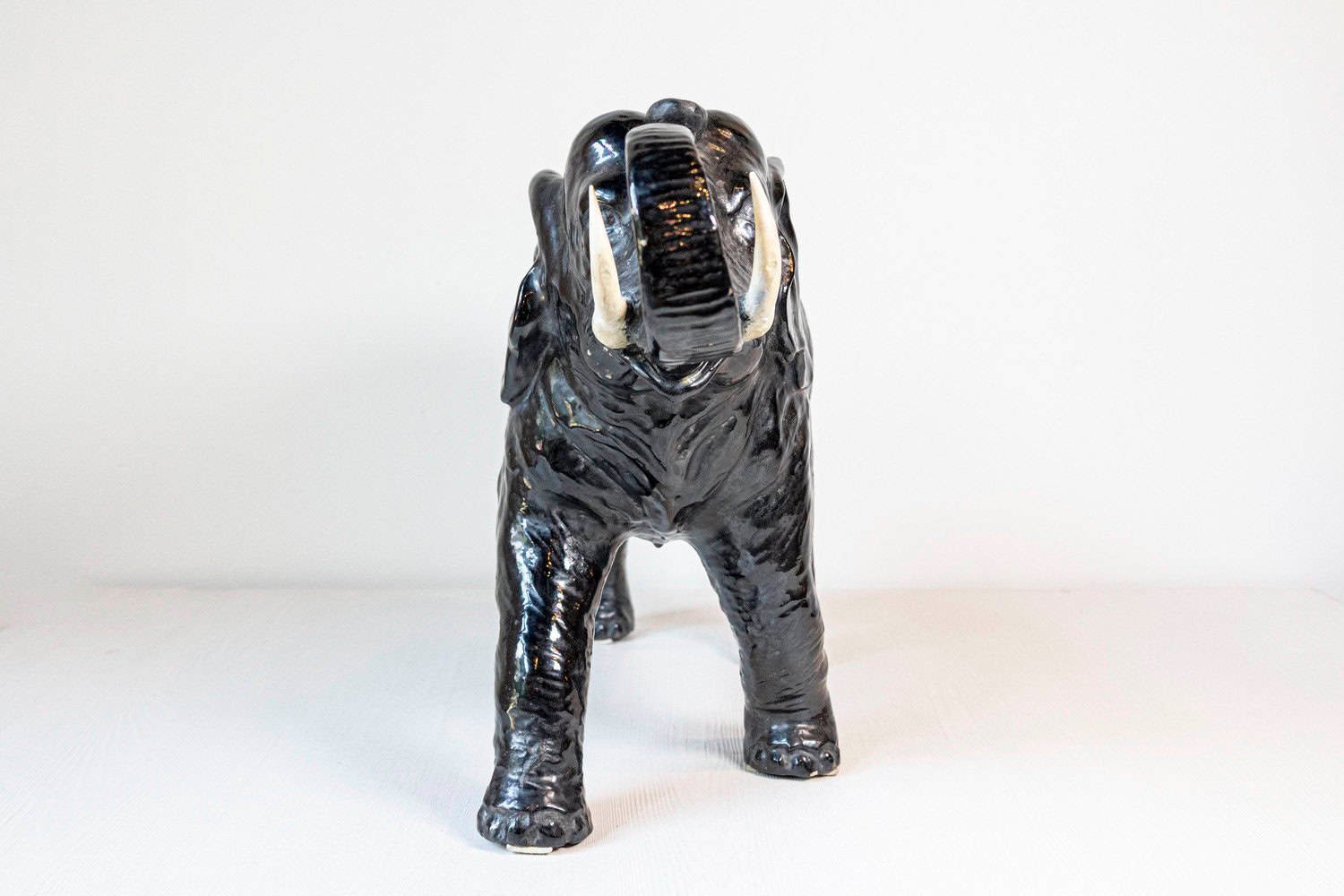 Italian 20th Century Black Glazed Ceramic Sculpture of a Walking Elephant with Trunk Up - JAA