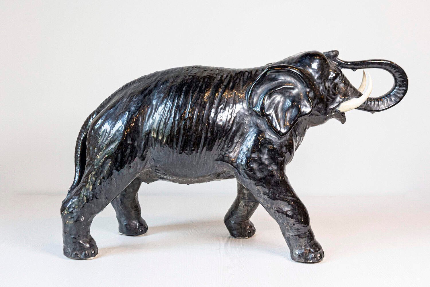 Italian 20th Century Black Glazed Ceramic Sculpture of a Walking Elephant with Trunk Up - JAA