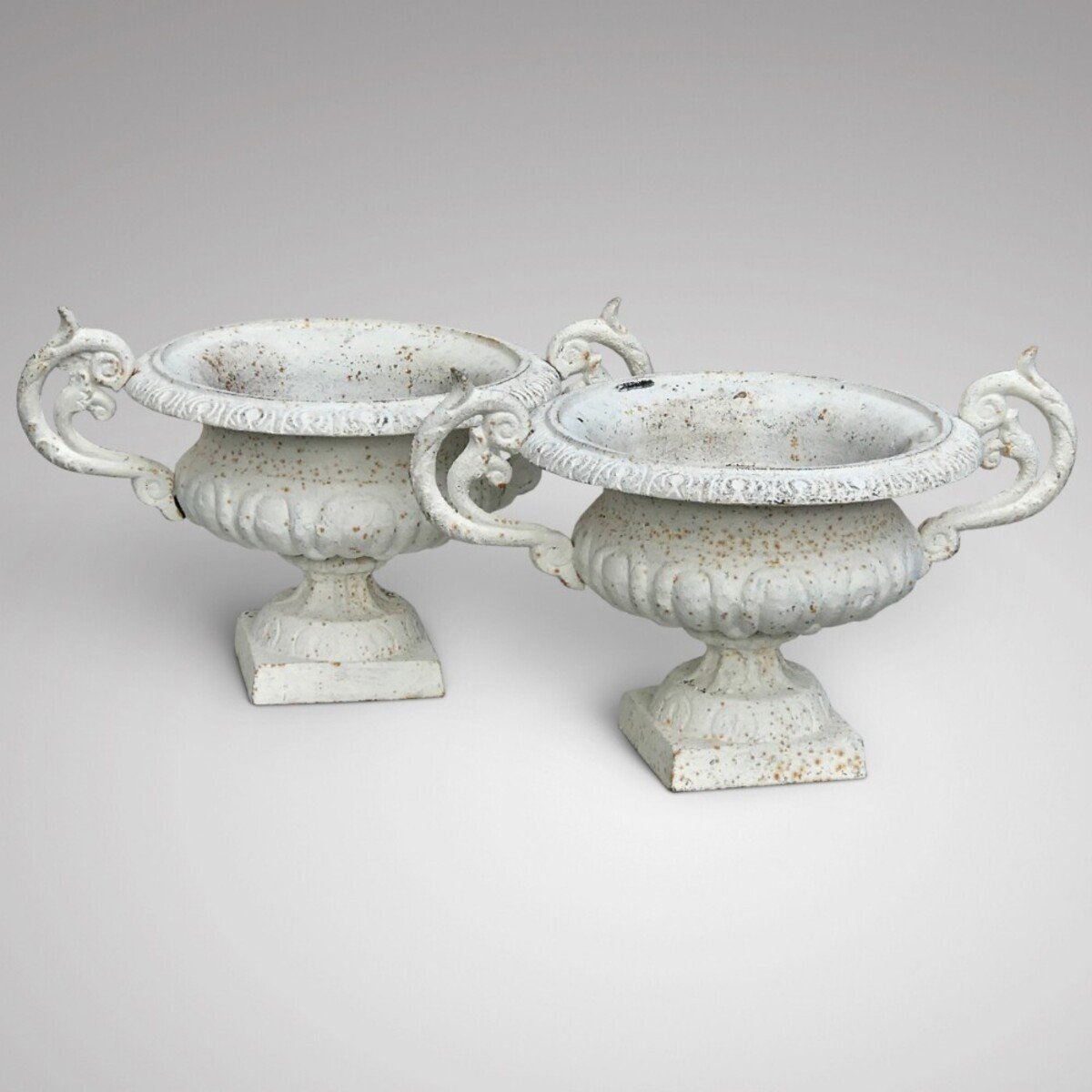 An excellent pair of 19th century cast iron garden urns with twin scrolled handles - JAA