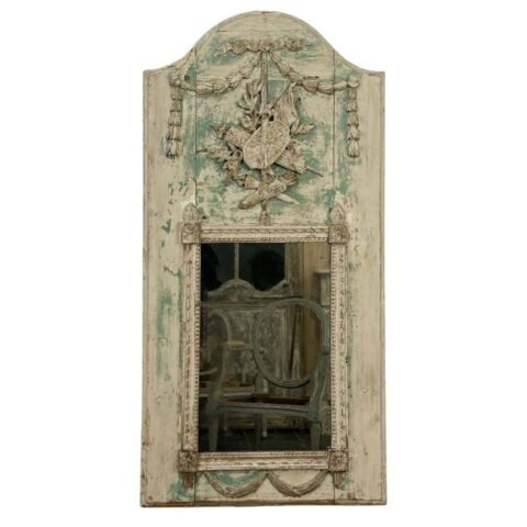 Superb small Louis XVI period trumeau mirror in carved wood decorated with warrior attributes, originally painted.