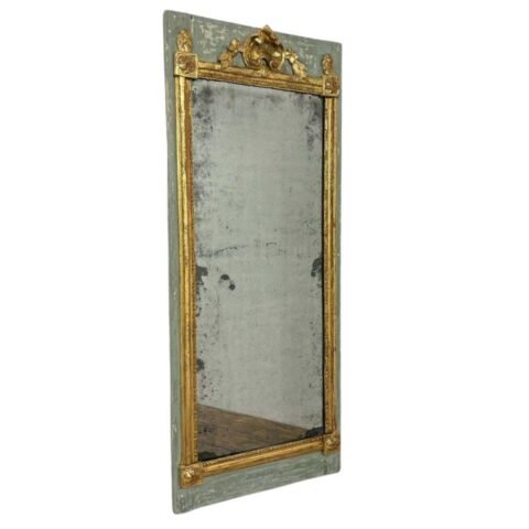 Beautiful mirror between two 18th-century wood paneling panels in carved gilded wood on a painted background