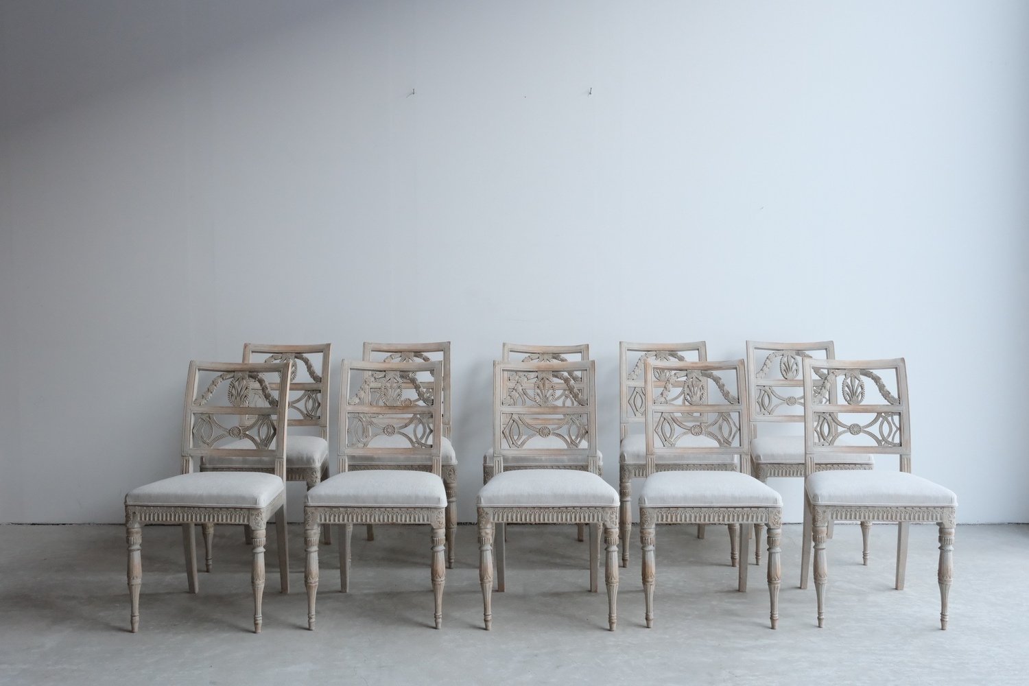A matched set of 10 unusual period Gustavian chairs, made in Lindome, repainted and newly upholstered in linen - JAA