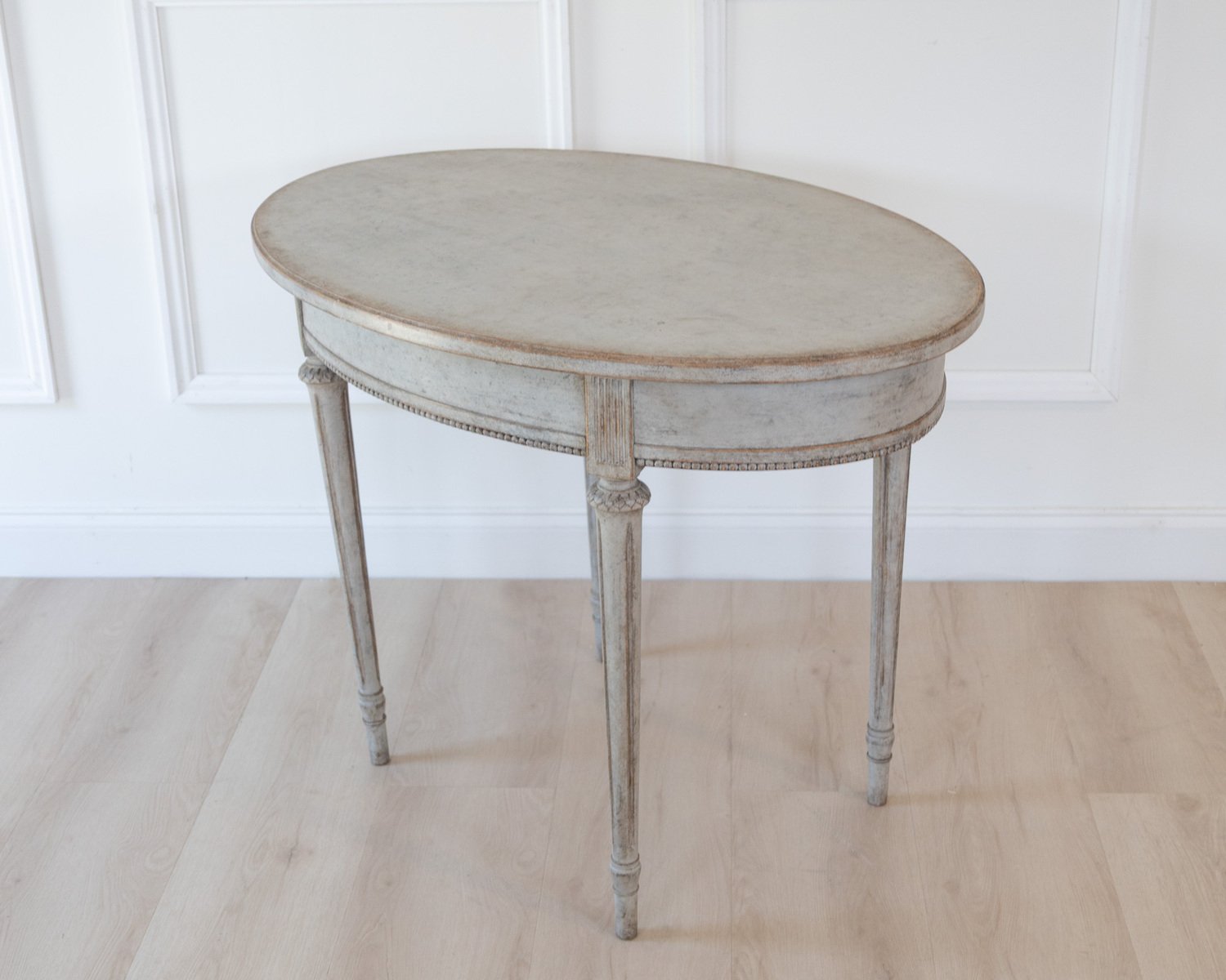 Oval table in the Gustavian style is finished in grey. - JAA